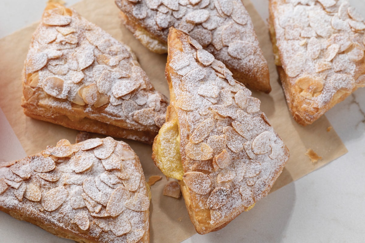 Almond Pastries Topped with Sliced Almonds and Powdered Sugar