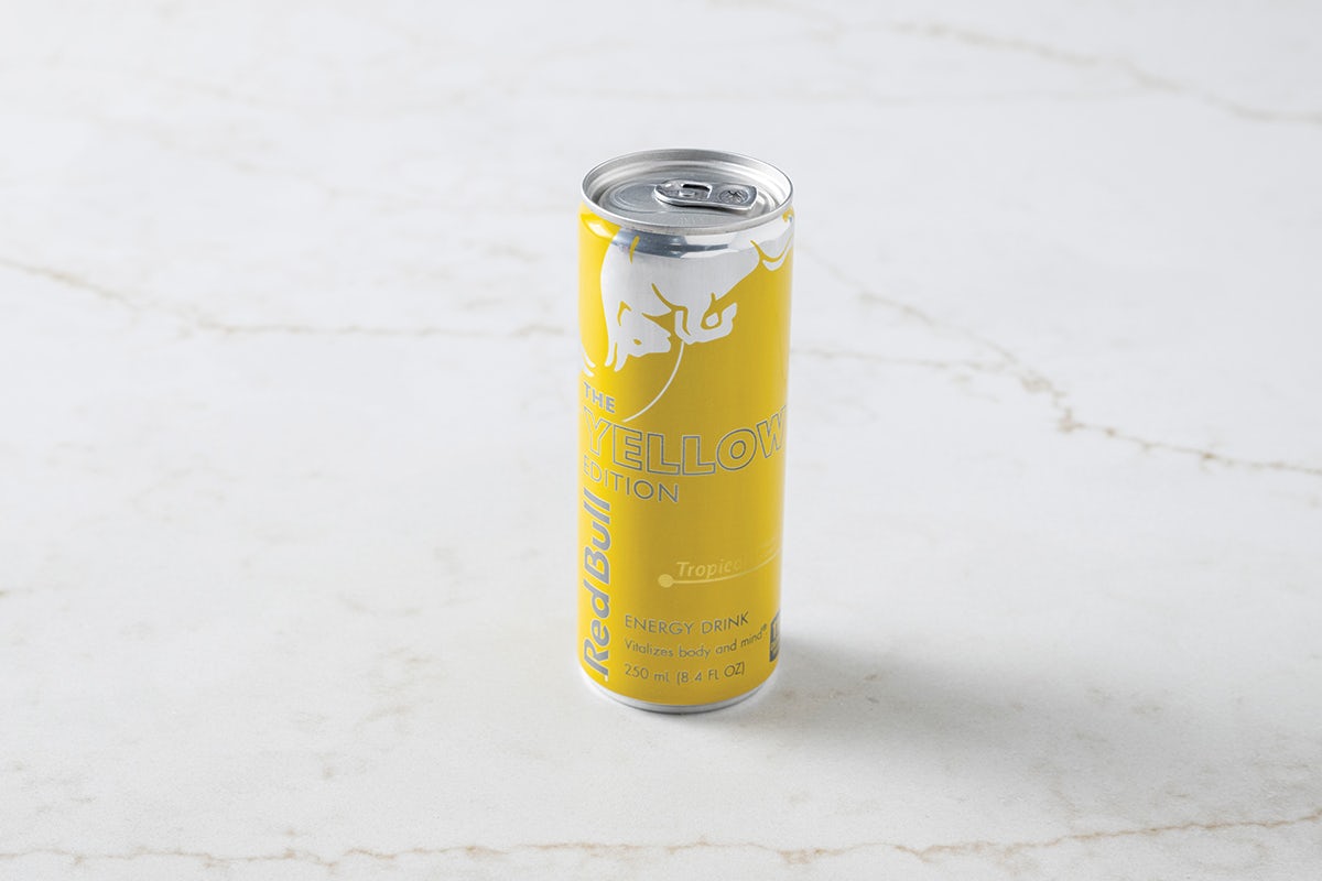 Can of Yellow Tropical Red Bull Energy Drink